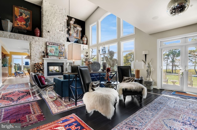 11209 Woodside Dr, Berlin, MD 21811 - living room with a high ceiling, a multi sided fireplace, french doors, and wood finished floors