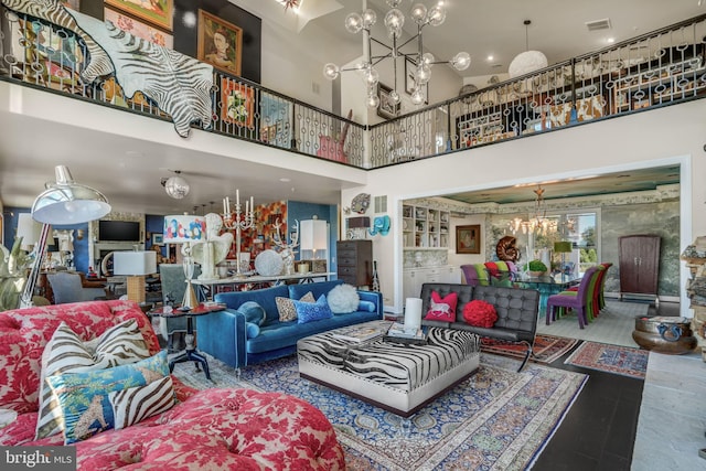 living room with a notable chandelier and a high ceiling