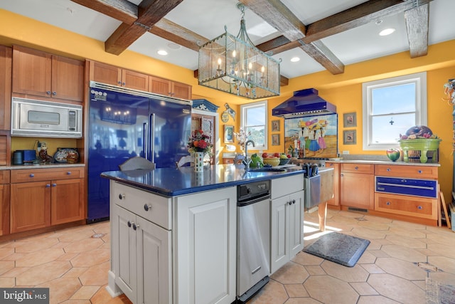 kitchen featuring stainless steel microwave, black fridge, plenty of natural light, and white cabinets