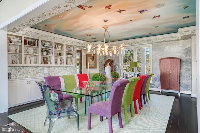 11209 Woodside Dr, Berlin, MD 21811 - dining space featuring wallpapered walls, dark wood finished floors, and an inviting chandelier