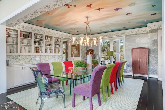 dining room with dark hardwood / wood-style floors and an inviting chandelier