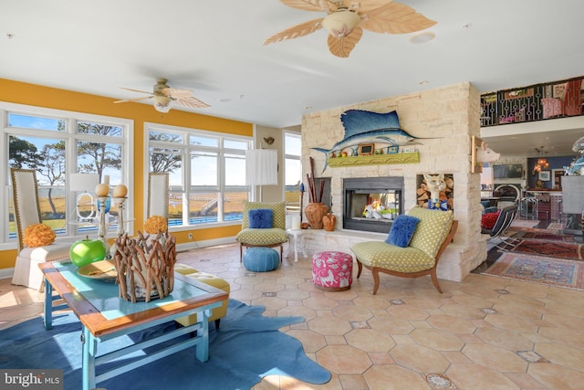 living room with a fireplace, tile patterned floors, and ceiling fan