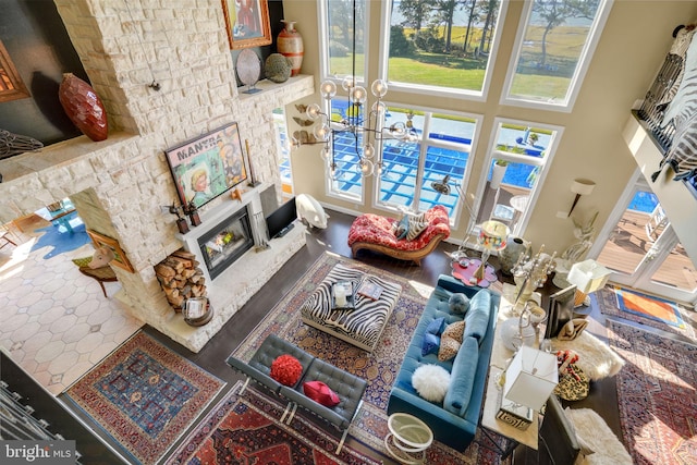 11209 Woodside Dr, Berlin, MD 21811 - living area with a warm lit fireplace, a notable chandelier, and a wealth of natural light