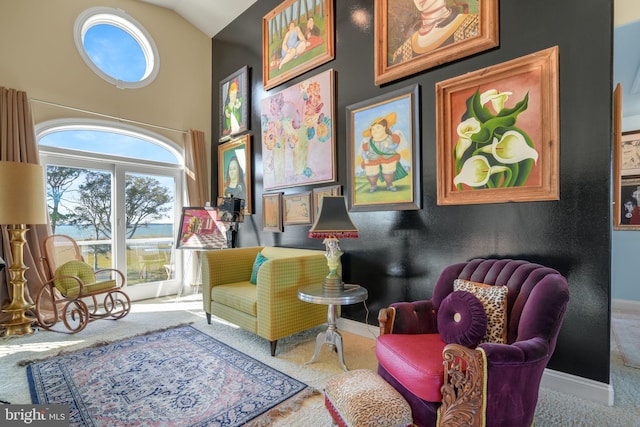 living area with carpet and lofted ceiling