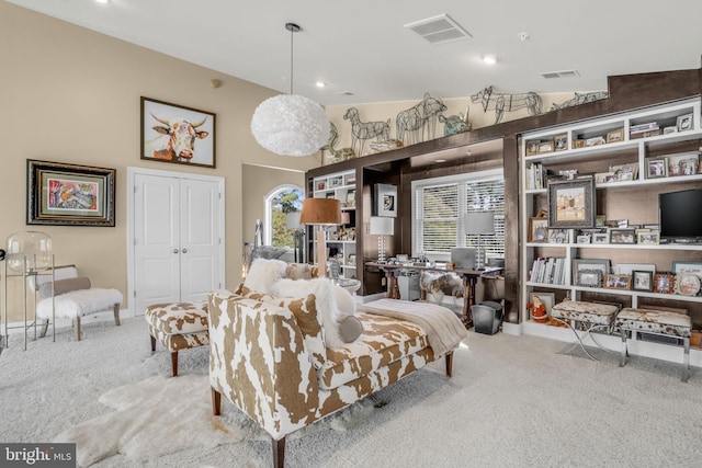 carpeted living room with a healthy amount of sunlight and lofted ceiling