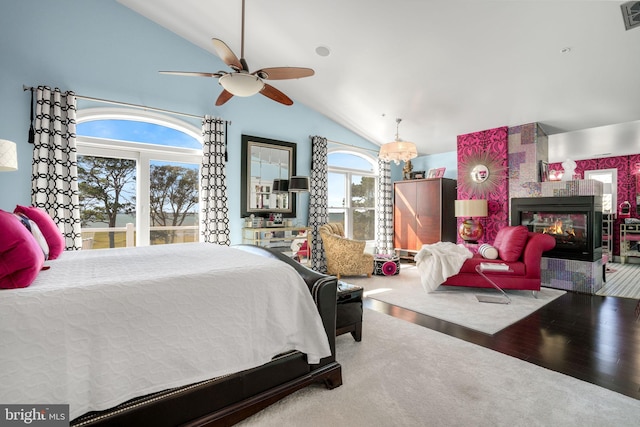 11209 Woodside Dr, Berlin, MD 21811 - bedroom with multiple windows, a tile fireplace, visible vents, and vaulted ceiling