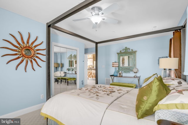 bedroom with ceiling fan, a closet, and light carpet