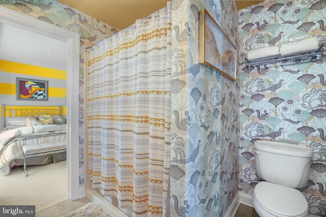 bathroom featuring toilet and tile patterned floors