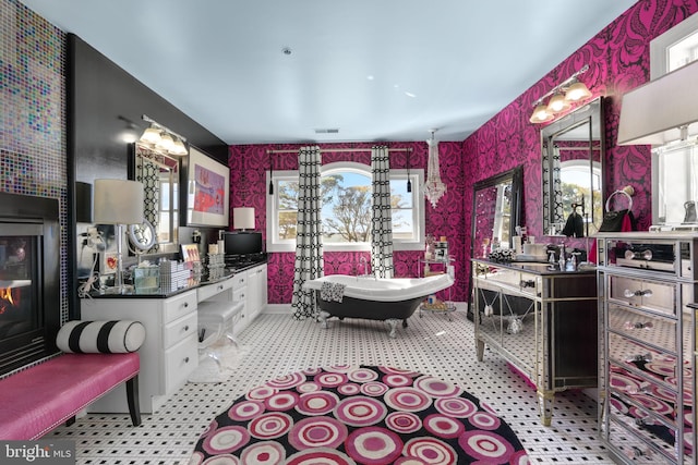 bathroom with vanity, plenty of natural light, and a tub