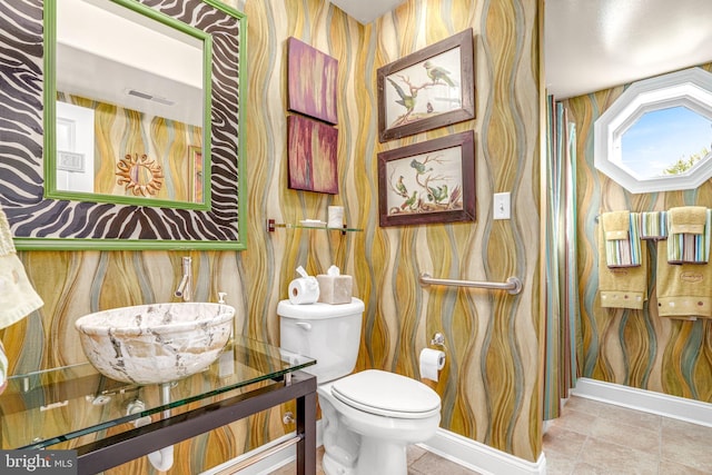 11209 Woodside Dr, Berlin, MD 21811 - half bath featuring toilet, tile patterned flooring, baseboards, and wallpapered walls