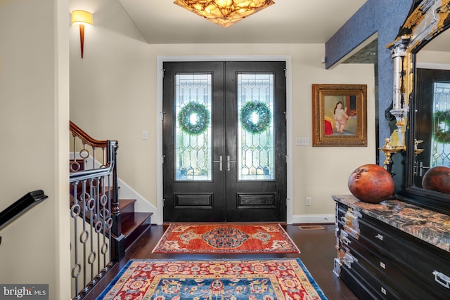 entrance foyer with french doors and dark hardwood / wood-style flooring