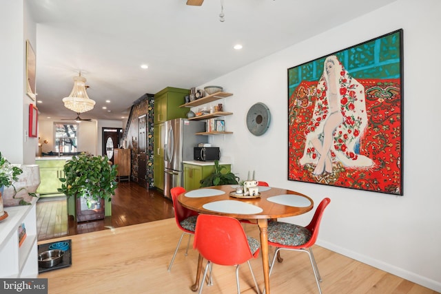 dining area with ceiling fan and hardwood / wood-style flooring