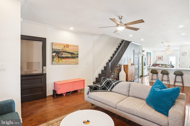 living room with crown molding, hardwood / wood-style floors, and ceiling fan