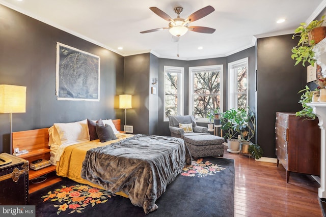 bedroom featuring dark hardwood / wood-style flooring, ceiling fan, and crown molding