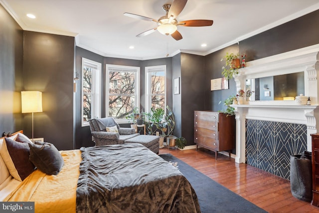 bedroom with ceiling fan, dark hardwood / wood-style flooring, and crown molding