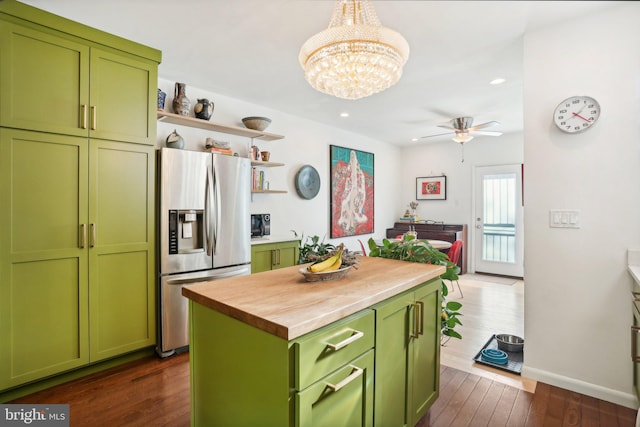 kitchen featuring stainless steel refrigerator with ice dispenser, green cabinetry, dark hardwood / wood-style floors, a kitchen island, and butcher block counters