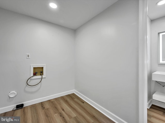 laundry area featuring hookup for a washing machine, hardwood / wood-style flooring, and hookup for an electric dryer