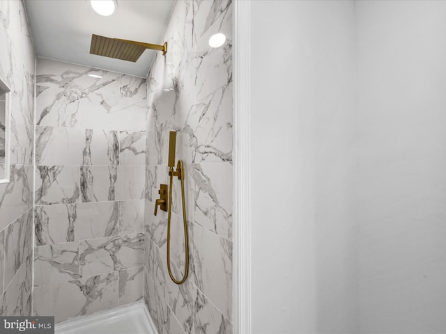 bathroom with a tile shower