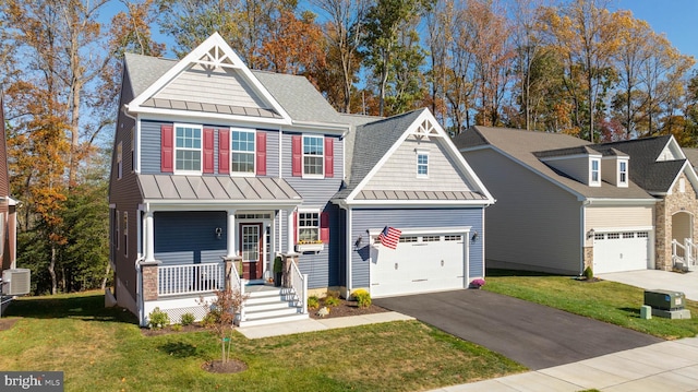 craftsman-style house featuring a garage, a front yard, and covered porch