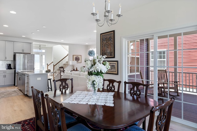 dining space featuring a chandelier and light wood-type flooring