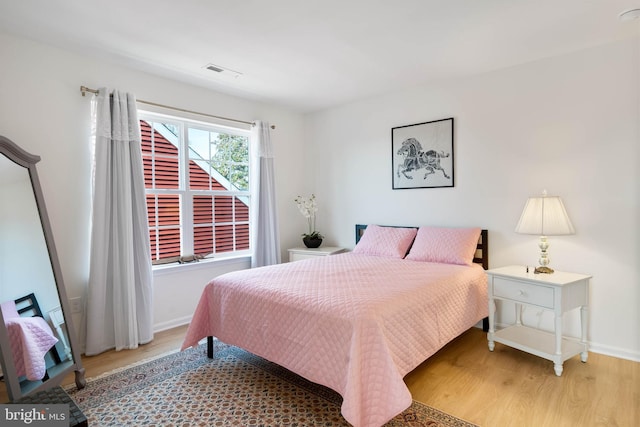 bedroom with wood-type flooring