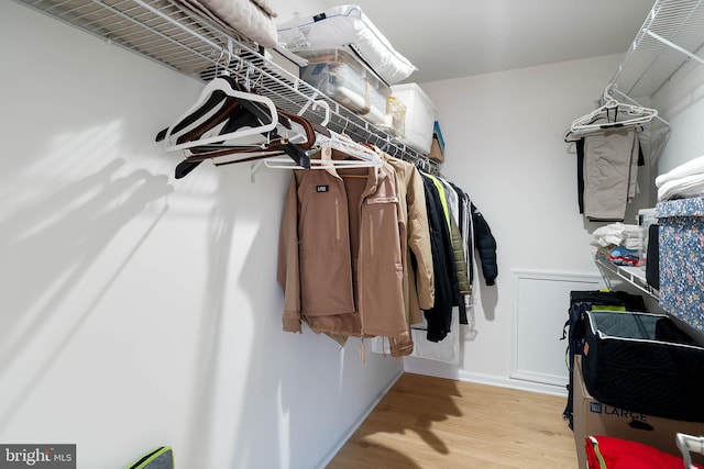 walk in closet featuring light hardwood / wood-style flooring