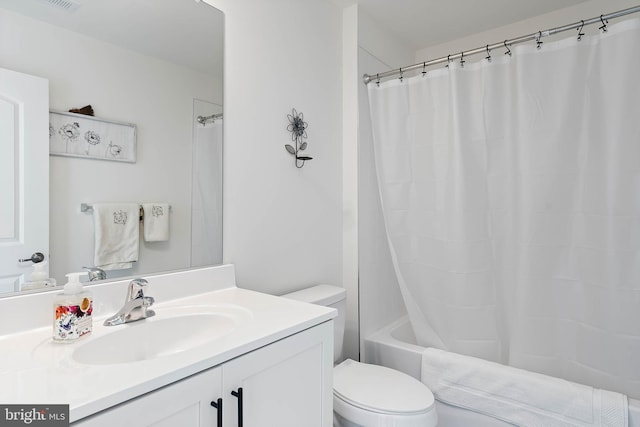 full bathroom featuring vanity, shower / tub combo, and toilet