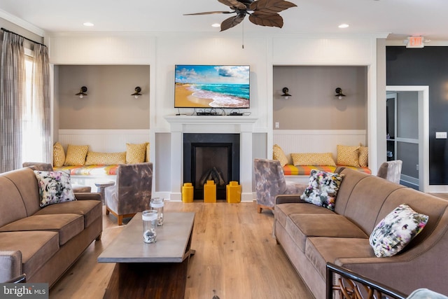 living room featuring ceiling fan, ornamental molding, light hardwood / wood-style floors, and a wealth of natural light