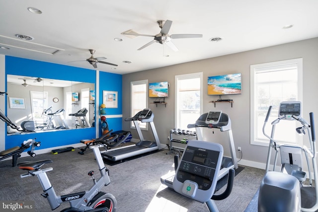 workout area with ceiling fan, plenty of natural light, and carpet