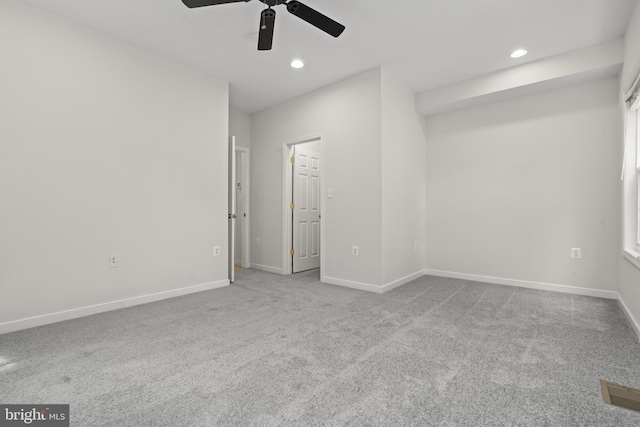 empty room with light colored carpet and ceiling fan