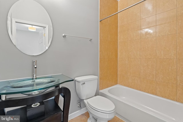 full bathroom with toilet, tiled shower / bath combo, vanity, and tile patterned flooring