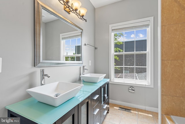 bathroom with vanity, plenty of natural light, and tile patterned flooring