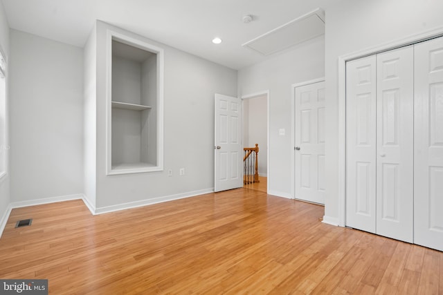 unfurnished bedroom with light wood-type flooring