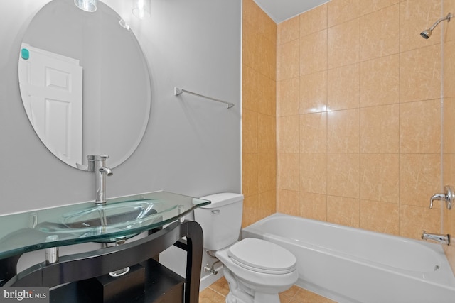 full bathroom featuring vanity, tiled shower / bath combo, toilet, and tile patterned flooring