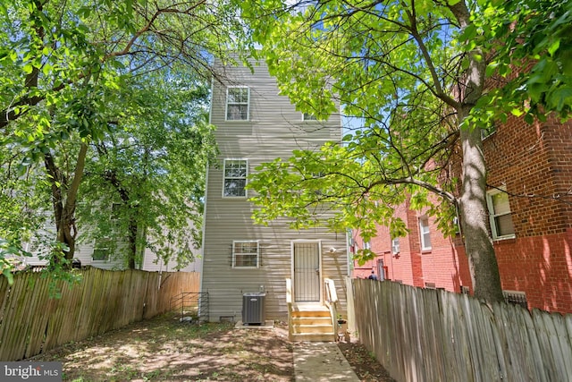 rear view of property with cooling unit