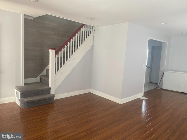 staircase with hardwood / wood-style flooring