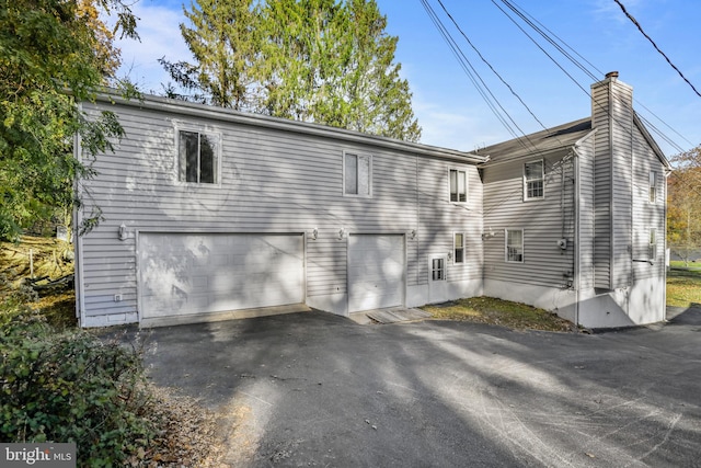 rear view of property featuring a garage