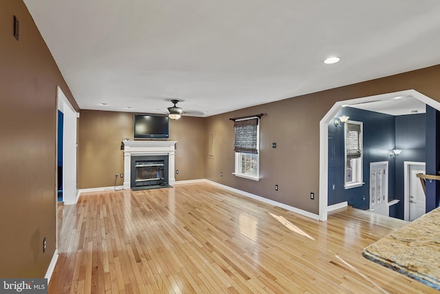 unfurnished living room featuring light hardwood / wood-style floors and ceiling fan