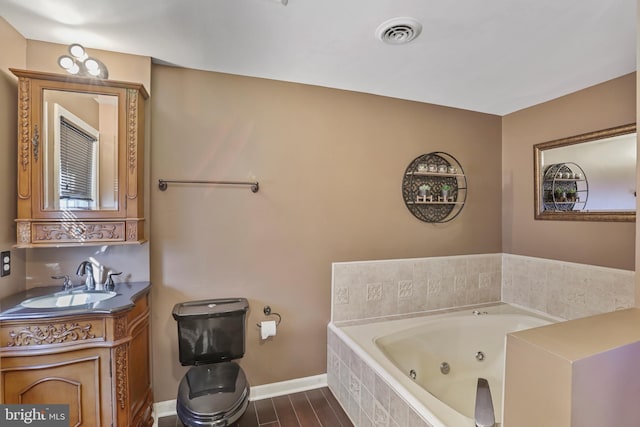 bathroom with vanity and a relaxing tiled tub