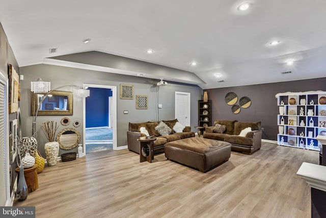 living room with vaulted ceiling and light hardwood / wood-style floors