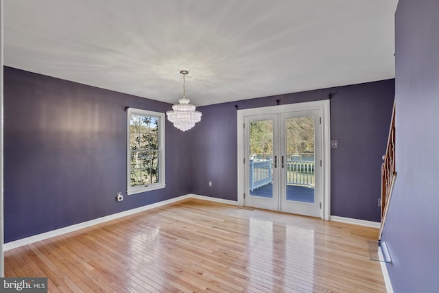 unfurnished dining area featuring a wealth of natural light, light hardwood / wood-style flooring, and french doors