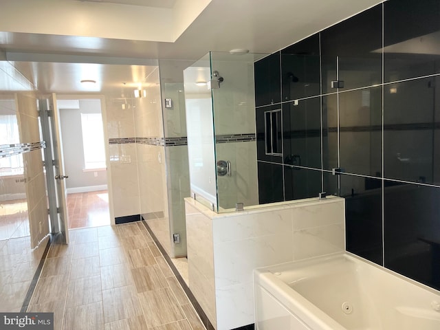 bathroom with separate shower and tub