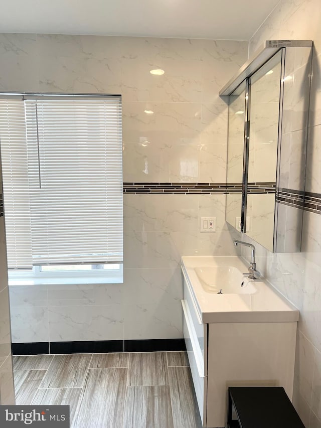 bathroom featuring vanity, tile walls, and an enclosed shower