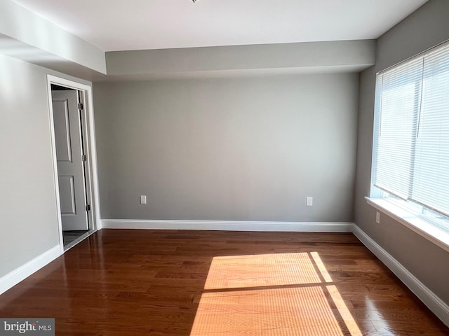 spare room featuring dark hardwood / wood-style floors