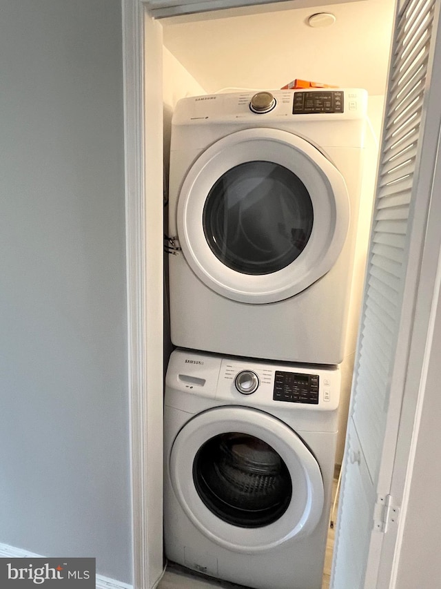 laundry area with stacked washer / drying machine