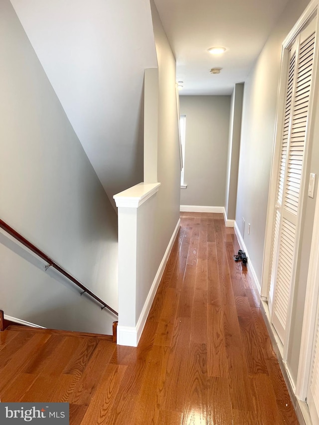 hallway with hardwood / wood-style flooring