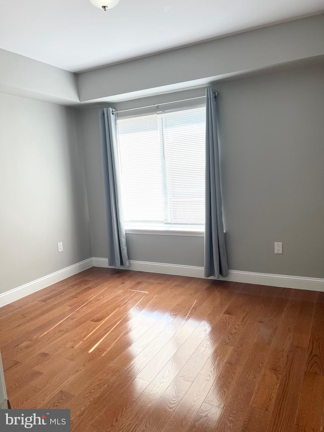 unfurnished room featuring hardwood / wood-style flooring