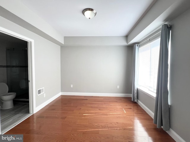 spare room featuring wood-type flooring