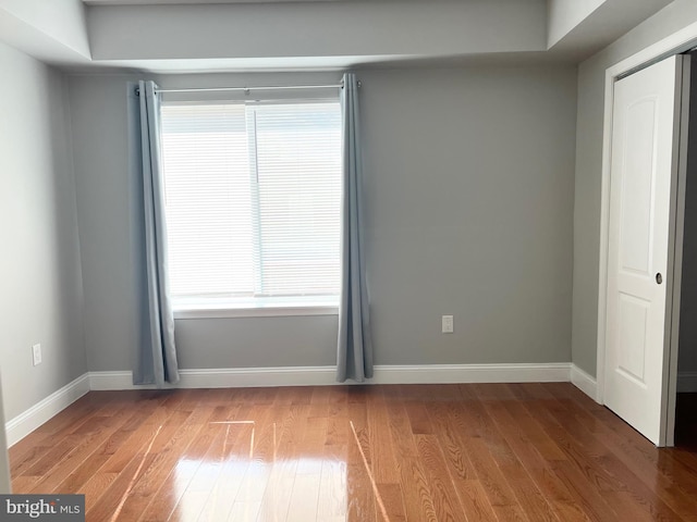 spare room with hardwood / wood-style floors