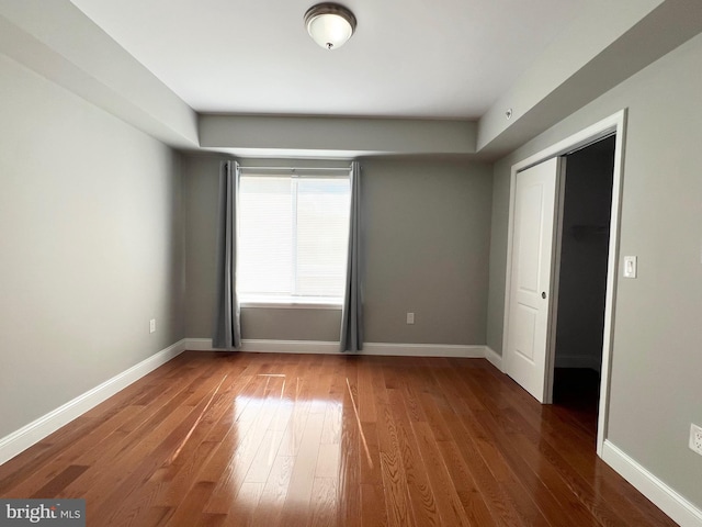 spare room with dark wood-type flooring